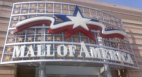 Outside of Mall of America sign with white mall of america letters and red, white and blue starts on the sign of mall of america.