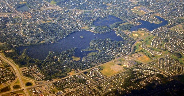 Aerial photo of the lake around burnsville with highways and green grass sprinked around the lake.