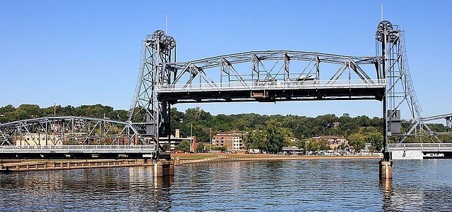 Stillwater bridge on a clear day with a blue background and a calm river below.